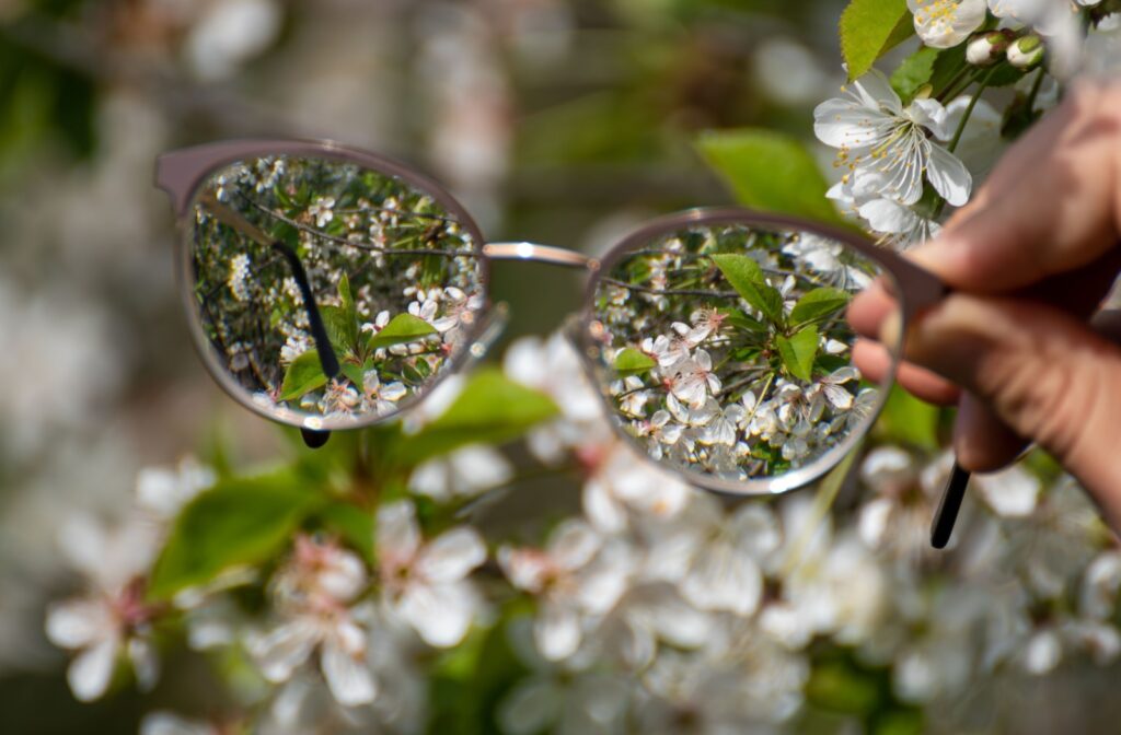 A pair of glasses where you can see the plants in front clearly when looking through the lens